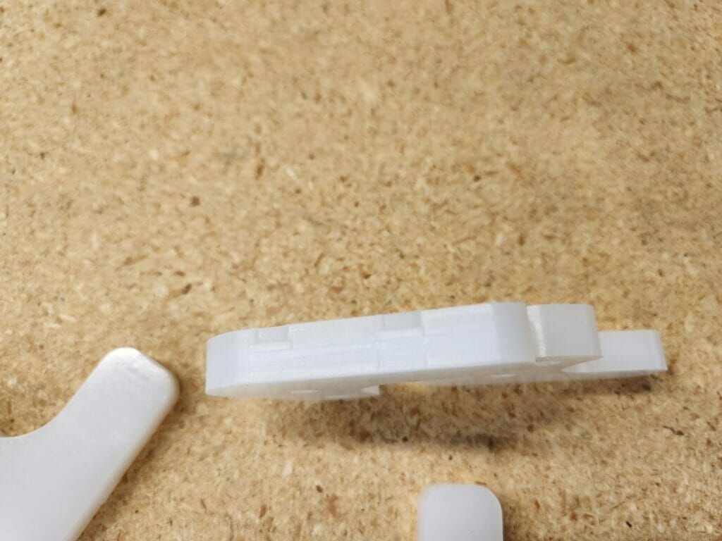 Two fixture tabs on a 0.375” thick UHMW part.