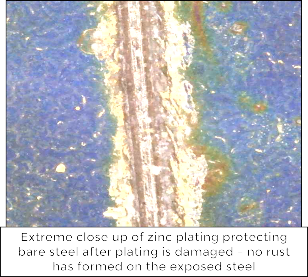 extreme close up of zinc plating protecting bare steel after plating is damaged 