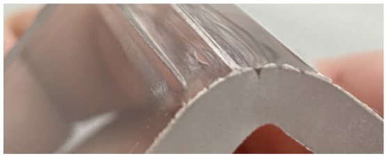 Bent polycarbonate part with surface cracks